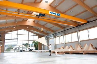 ABUS double girder overhead travelling crane operated by employee in carpentry Baierl